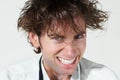 Crazy, portrait and mad scientist man on white background with stress, mistake and insane hair. Mental health, psychosis