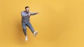 Crazy Sales. Excited asian man jumping up in air and pointing aside Royalty Free Stock Photo