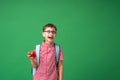 Crazy schoolboy holds glasses and Apple in his hands