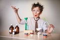 Crazy scientist. Young boy performing experiments Royalty Free Stock Photo