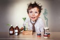 Crazy scientist. Young boy performing experiments