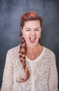 Crazy screaming woman on blackboard background