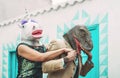 Crazy senior couple wearing unicorn and t-rex mask while dancing outdoor - Mature trendy people having fun celebrating carnival Royalty Free Stock Photo