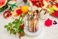 Crazy shake on top with marshmallow, waffles, biscuits and sweets on a bright colored background Royalty Free Stock Photo