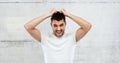 Crazy shouting man in t-shirt over gray background