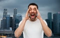 Crazy shouting man in t-shirt over singapore city