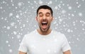 Crazy shouting man in t-shirt over snow background Royalty Free Stock Photo