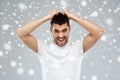 Crazy shouting man in t-shirt over snow background Royalty Free Stock Photo