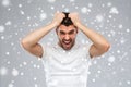 Crazy shouting man in t-shirt over snow background Royalty Free Stock Photo