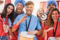 Crazy sport fans playing drums and screaming while supporting their team Royalty Free Stock Photo