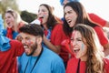Crazy sport fans screaming while supporting their football team - Main focus on right girl face Royalty Free Stock Photo