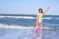 Crazy sporty woman is expressively laughing on the beach