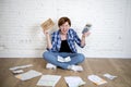 Crazy stressed woman with calculator and bank and bills paperwork and documents doing domestic financial accounting