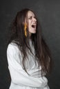 Crazy woman screaming in a straitjacket. Royalty Free Stock Photo