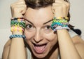 Crazy young woman with colorful rubber bracelets on her hands