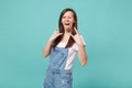 Crazy young woman girl in casual denim clothes isolated on blue turquoise background. People lifestyle concept. Mock up Royalty Free Stock Photo