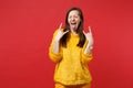 Crazy young woman with horns up gesture, depicting heavy metal rock sign, showing tongue, keeping eyes closed isolated Royalty Free Stock Photo