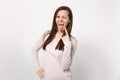 Crazy young woman in light clothes showing tongue, horns up gesture, depicting heavy metal rock sign isolated on white Royalty Free Stock Photo