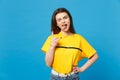 Crazy young woman in vivid casual clothes showing tongue, depicting heavy metal rock sign, horns up gesture isolated on Royalty Free Stock Photo