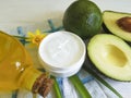 cream, avocado mask oil wellness on a wooden background, flower