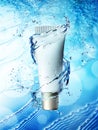 Cream bottle mock up in water splash on blue background. Royalty Free Stock Photo