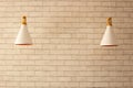 Cream brick wall and two white forms of lamp