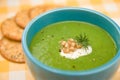 Cream of Broccoli in blue bowl with crackers