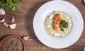 Cream of broccoli soup with salmon top view a wooden background Royalty Free Stock Photo