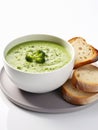 Cream of broccoli soup served with slices of bread.