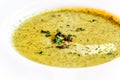 Cream of brocolli soup with bacon bits served in a white china soup plate Royalty Free Stock Photo