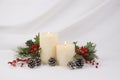 Cream burning candles decorated during Christmas time Royalty Free Stock Photo