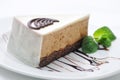 Cream cake on white plate, chocolate topping with cake, patisserie, sweet tart with mint leaf, shop, cocoa cream