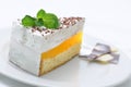 Cream cake on white plate, sweet dessert with mint leaf and chocolate decoration, patisserie, sweet dessert, on-line shop photo