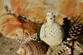 Cream ceramic snowman on beach sand shell pine cone african beads Christmas in July Royalty Free Stock Photo