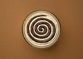 Cream cheese with chocolate cream swirl on brown background, top view Royalty Free Stock Photo