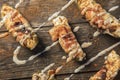 Cream Cheese Filled Bacon Wrapped Jalapeno Poppers On Wood Background