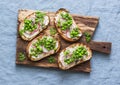 Cream cheese, green peas, radishes and micro greens spring sandwiches on a cutting board. Healthy eating, slimming, diet lifestyle Royalty Free Stock Photo