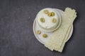 Cream cheese with olives and long chips in a bowl on a dark background. Top view and copyspace. Food for snacks