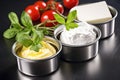 cream cheese in shiny stainless steel containers