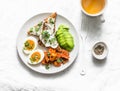 Cream cheese toast, avocado, boiled egg, baked sweet potatoes - delicious healthy breakfast or snack on a light background Royalty Free Stock Photo