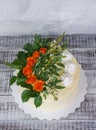 Cream cheese vanilla wedding cake with orange roses Royalty Free Stock Photo