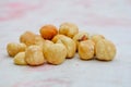Cream color roasted hazelnuts on a table. A handful of nuts, peeled and toasted for trail mix.Healthy snack for vegans