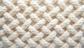 Cream colored braided rope texture with diagonal interwoven pattern. Close-up view shows thick strands creating a visually Royalty Free Stock Photo