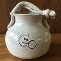Cream-colored ceramic jug with a round, plump shape and smooth texture. Features a Royalty Free Stock Photo