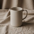 Cream-colored ceramic pitcher with a simple, Royalty Free Stock Photo