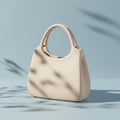 Cream-colored handbag with a smooth texture, featuring a minimalist design. It has Royalty Free Stock Photo