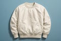 a clean product shot showcasing a stylish, cream-colored pullover sweatshirt on a light blue background, perfect for online retail Royalty Free Stock Photo