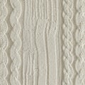 Cream-colored knitted fabric featuring a cable knit pattern Royalty Free Stock Photo