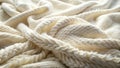 Cream-colored knitted textile with a textured, cable-knit pattern, soft and cozy, ideal for winter apparel or home decor. Royalty Free Stock Photo