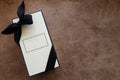 Cream Colored Rectangular Box with Black Ribbon